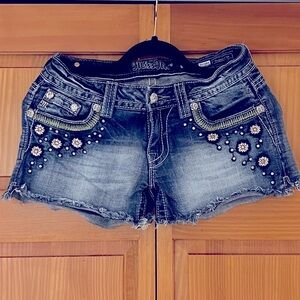 MISS ME. Blue short denim shorts with rhinestones and pattern. Size 27
